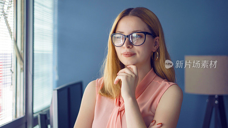 Horizontal shot of pleasant looking successful professional female lawyer learns clients case, dressed in formal apparel and transparent glasses,